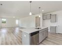 Bright kitchen features gray cabinets, white countertops, stainless appliances, and a center island at 1248 Randwick Valley Ct, Zebulon, NC 27597