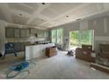 Spacious unfinished kitchen features gray cabinets, large windows, and an island perfect for entertaining at 1248 Randwick Valley Ct, Zebulon, NC 27597