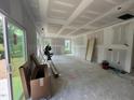 Spacious, unfinished living room with large windows offering natural light and scenic views at 1248 Randwick Valley Ct, Zebulon, NC 27597