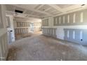 Spacious living room showcasing drywall installation progress with unfinished floors at 13159 S Nc-231 Hwy, Middlesex, NC 27557
