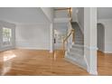 Elegant foyer featuring hardwood floors, staircase with carpet runner, and neutral paint at 15 Aman Ct, Durham, NC 27713