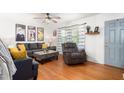 Bright living room with hardwood floors, striped curtains and comfortable seating at 1703 Keogh St, Burlington, NC 27215