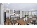 Open-concept kitchen boasts an island with seating, stainless steel appliances, and modern finishes at 1740 Golden Honey Dr, Wake Forest, NC 27587