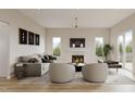 Inviting living room featuring a cozy fireplace, ample seating, and a neutral color palette at 203 E Winmore Ave, Chapel Hill, NC 27516