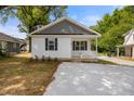 A charming home featuring a welcoming porch with a new concrete driveway at 208 W Holt St, Burlington, NC 27217
