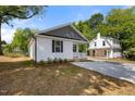 A charming home with black shutters, gray shingle and a concrete driveway at 208 W Holt St, Burlington, NC 27217