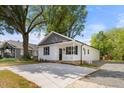 View of charming single-story home with new driveway and manicured lawn at 208 W Holt St, Burlington, NC 27217