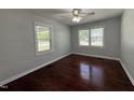 Cozy bedroom with hardwood floors and sunlit windows at 213 N Brevard St, Selma, NC 27576