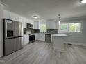 Modern kitchen features stainless steel appliances and white cabinetry at 213 N Brevard St, Selma, NC 27576
