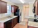 Efficient kitchen showcasing granite countertops, stainless steel appliances, and dark wood cabinets at 2193 Boyd Creek Dr, Graham, NC 27253