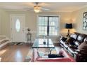 Well-lit living room with hardwood flooring, neutral colors, and modern decor accents at 2193 Boyd Creek Dr, Graham, NC 27253
