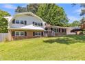 Charming two-story brick home with manicured lawn, attached garage, and beautiful mature trees at 2300 Radius Cir, Sanford, NC 27330