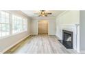 Bright and airy living room featuring neutral walls, fireplace, decorative light fixture, and lots of natural light at 2300 Radius Cir, Sanford, NC 27330