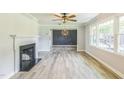Bright and airy living room featuring neutral walls, fireplace, decorative light fixture, and lots of natural light at 2300 Radius Cir, Sanford, NC 27330