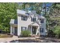 Well-maintained home with white siding, a gray roof, black shutters, and a landscaped front yard at 24 W Canterbury Ct, Wendell, NC 27591