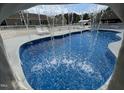 Unique view of a custom pool waterfall feature that enhances the backyard oasis at 2483 Mcneill Hobbs Rd, Bunnlevel, NC 28323