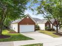 Charming home with a brick and siding exterior, well-manicured lawn, and a two-car garage at 2536 Bent Green St, Raleigh, NC 27614