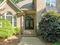 Close-up of the arched front door with decorative wrought iron and brick entrance at 266 Hogans Valley Way, Cary, NC 27513