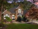 Elegant brick home with lush landscaping, providing a welcoming and serene atmosphere at 266 Hogans Valley Way, Cary, NC 27513