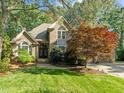 Charming brick home with a landscaped front yard and mature trees offering curb appeal at 266 Hogans Valley Way, Cary, NC 27513