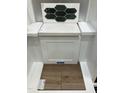 Interior design choices featuring dark green hexagon tiles, white countertop, and wood look flooring at 331 Chesapeake Cmns St # 106, Garner, NC 27529