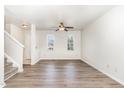 Bright living room featuring hardwood floors, a ceiling fan, and natural light from several windows at 3713 Phillips W Way, Durham, NC 27713