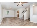 Open living room with ceiling fan, fresh paint, hardwood floors and easy access to staircase and kitchen at 3713 Phillips W Way, Durham, NC 27713