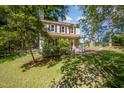 View of home's front facade showing covered porch and well-maintained lawn at 40 Crepe Myrtle Ct, Angier, NC 27501
