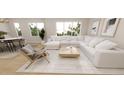 Spacious living room featuring a plush white sectional, wood floors, and natural light at 410 Chatham View Rd, Cary, NC 27511