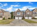 Attractive brick townhomes with double garages, set against a clear blue sky at 416 Durants Neck Ln, Morrisville, NC 27560