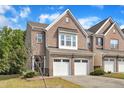 Beautiful brick townhome featuring a two-car garage and inviting front yard at 416 Durants Neck Ln, Morrisville, NC 27560