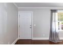 Bright and spacious living room with hardwood floors and large window with backyard view at 4221 River Run Dr, Sanford, NC 27332