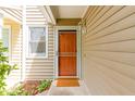 Close-up view of the front door entrance with a storm door, new lighting and a welcoming door mat at 509 Darby Glen Ln, Durham, NC 27713