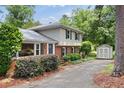 Charming home with a well-manicured yard, brick and siding exterior, and storage shed at 509 E Millbrook Rd, Raleigh, NC 27609