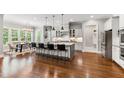 Spacious kitchen features a large center island with bar stools and stainless steel appliances at 7116 Dumfries Ln, Chapel Hill, NC 27514