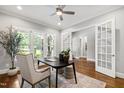 Bright office with hardwood floors, large windows, and French doors leading to another room at 7116 Dumfries Ln, Chapel Hill, NC 27514