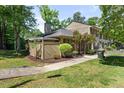 A nice exterior view of the house with a well-maintained lawn and mature trees in a desirable neighborhood at 75 Stone Hill Ct, Durham, NC 27704
