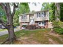 Charming split-level home featuring a brick-accented facade, attached garage, and well-maintained lawn at 7824 Hemlock Ct, Raleigh, NC 27615