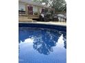 Sparkling pool reflects the sky, surrounded by deck and trees, inviting refreshing swims at 7824 Hemlock Ct, Raleigh, NC 27615