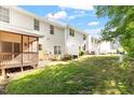 Expansive backyard showcasing a well-maintained lawn, screened porch, and a peaceful outdoor setting at 1 Edgebrook Cir, Durham, NC 27703