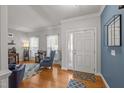 Bright living room featuring wood floors, natural light, a blue accent wall and modern decor at 1028 Bellenden Dr, Durham, NC 27713