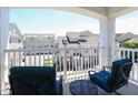 Inviting balcony featuring two blue cushioned chairs and a table, perfect for enjoying the view at 10529 Sablewood Dr # 116, Raleigh, NC 27617