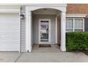 Close-up view of the front door showcasing the home's entryway, sidelights, and brick accents at 107 Caraleigh Ct, Morrisville, NC 27560