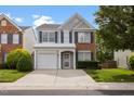 Charming two-story home featuring blue shutters, a one-car garage, and a well-maintained lawn at 107 Caraleigh Ct, Morrisville, NC 27560