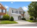 Charming two-story home featuring blue shutters, a one-car garage, and a well-maintained lawn at 107 Caraleigh Ct, Morrisville, NC 27560