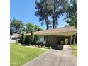 A cozy single-story home with brick facade, covered parking, and manicured greenery at 1157 S Cambridge Cir, Rocky Mount, NC 27801