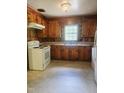 Traditional kitchen featuring wood cabinets, a white electric stove, and a double basin sink at 1157 S Cambridge Cir, Rocky Mount, NC 27801