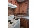 Close-up of kitchen showcasing wood cabinetry, white appliances, and laminate countertops at 1157 S Cambridge Cir, Rocky Mount, NC 27801