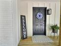 Inviting front entrance featuring a stylish black door with a floral wreath and 'welcome' sign at 116 Lumpkin St, Raleigh, NC 27610