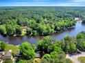 Picturesque waterfront homes nestled along a winding river, surrounded by lush greenery and mature trees at 135 Sagamore Dr, Louisburg, NC 27549